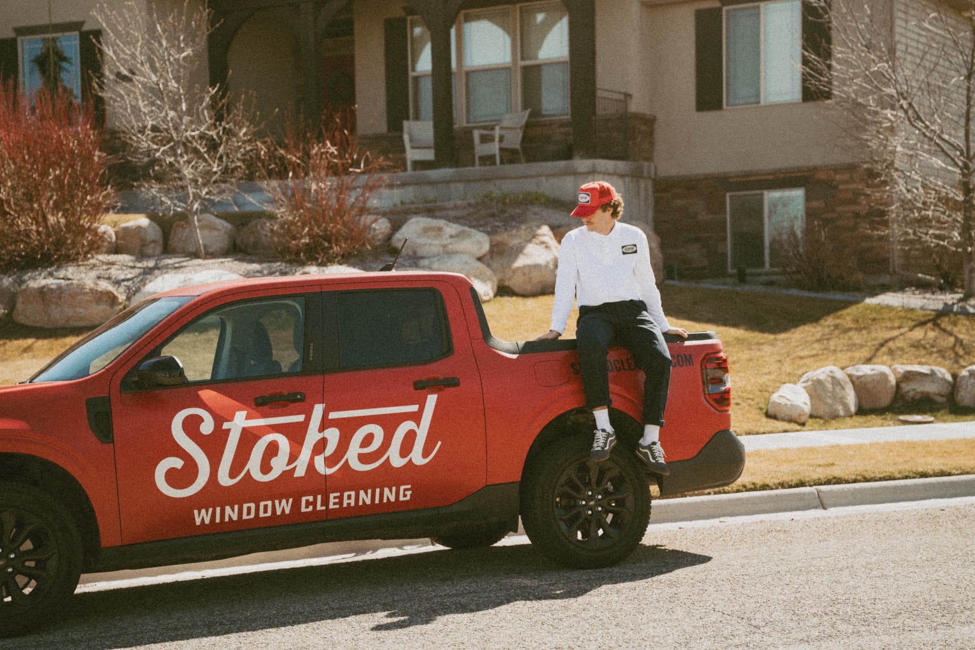 Stoked Window Cleaning truck parked outside an Idaho Falls home